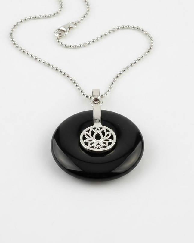 Black Agate lotus pendant necklace on silver chain – healing crystal jewelry for meditation and spiritual alignment.